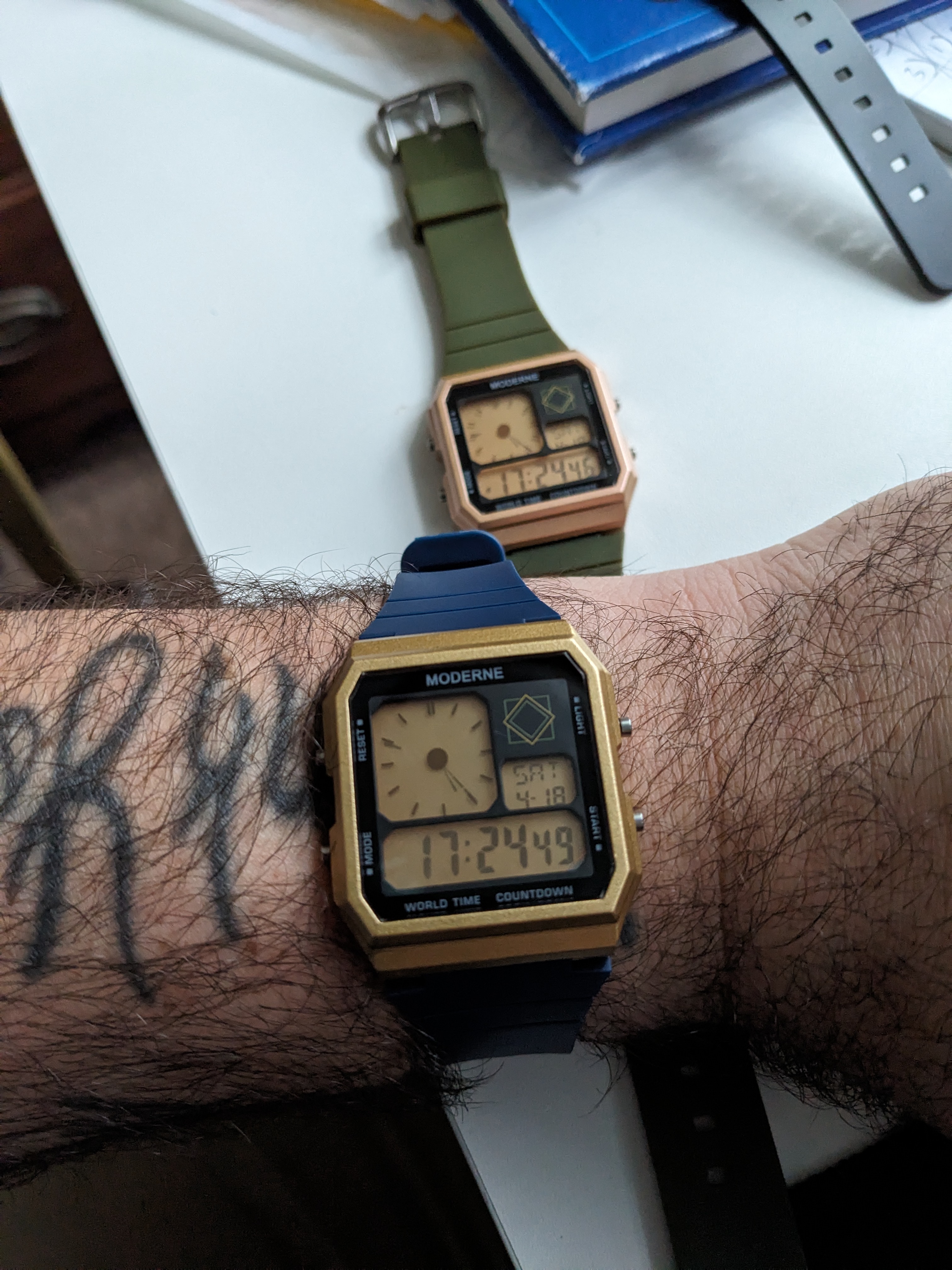The Moderne on wrist — Navy Blue with Gold case alongside Olive Green with Rose Gold